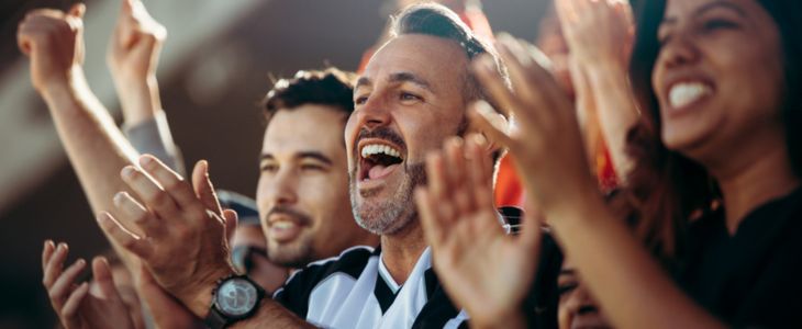 sports fans cheering at a stadium